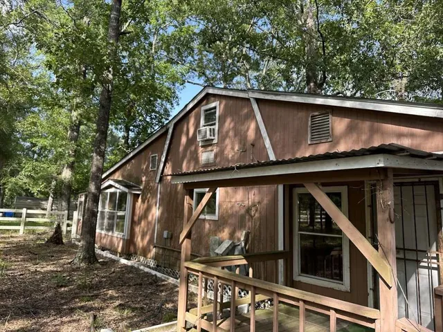 a roof deck with wooden floor and fence