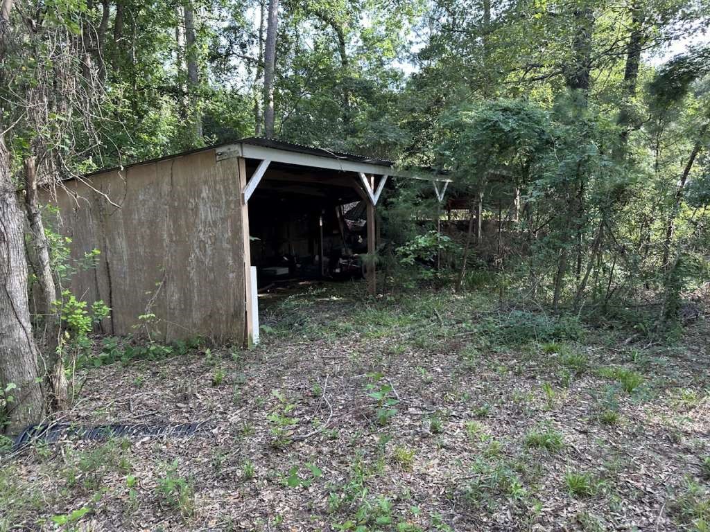110 Stewart Street Coldspring, TX 77331 - Photo 11 of 12 a backyard of a house with lots of green space
