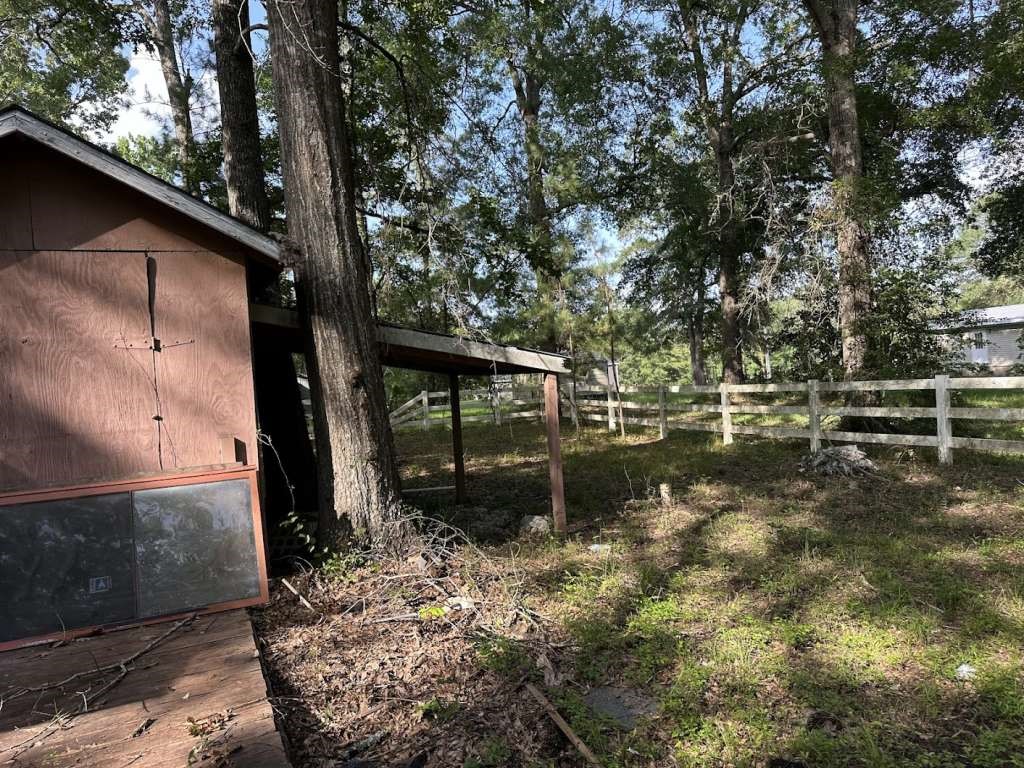 110 Stewart Street Coldspring, TX 77331 - Photo 12 of 12 a backyard of a house with lots of green space