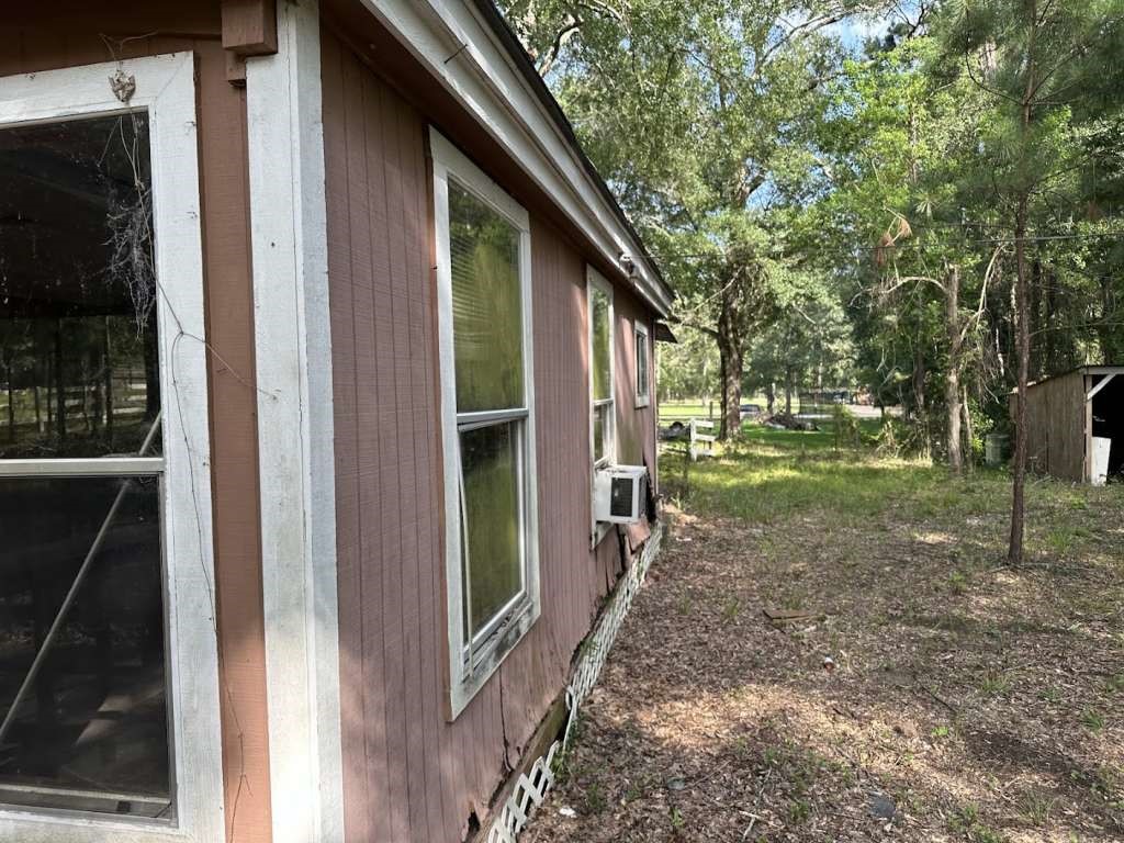 110 Stewart Street Coldspring, TX 77331 - Photo 2 of 12 a view of a house with backyard and trees