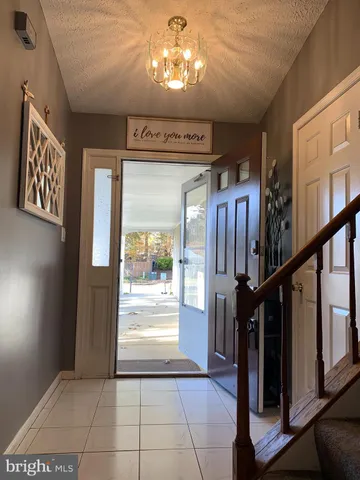 a view of entryway with a front door and wooden floor