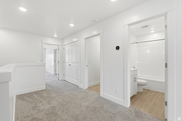 1173 West 1870 South Logan, UT 84321 - Photo 9 of 33 Upper level hallway featuring grey carpet, white walls, recessed lighting, and a white railing