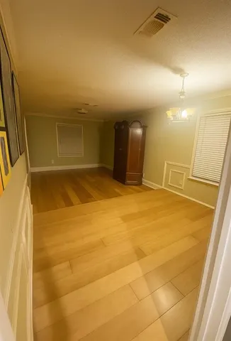 a view of a big room with closet and a ceiling fan