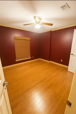 a spacious bedroom with a bed and window
