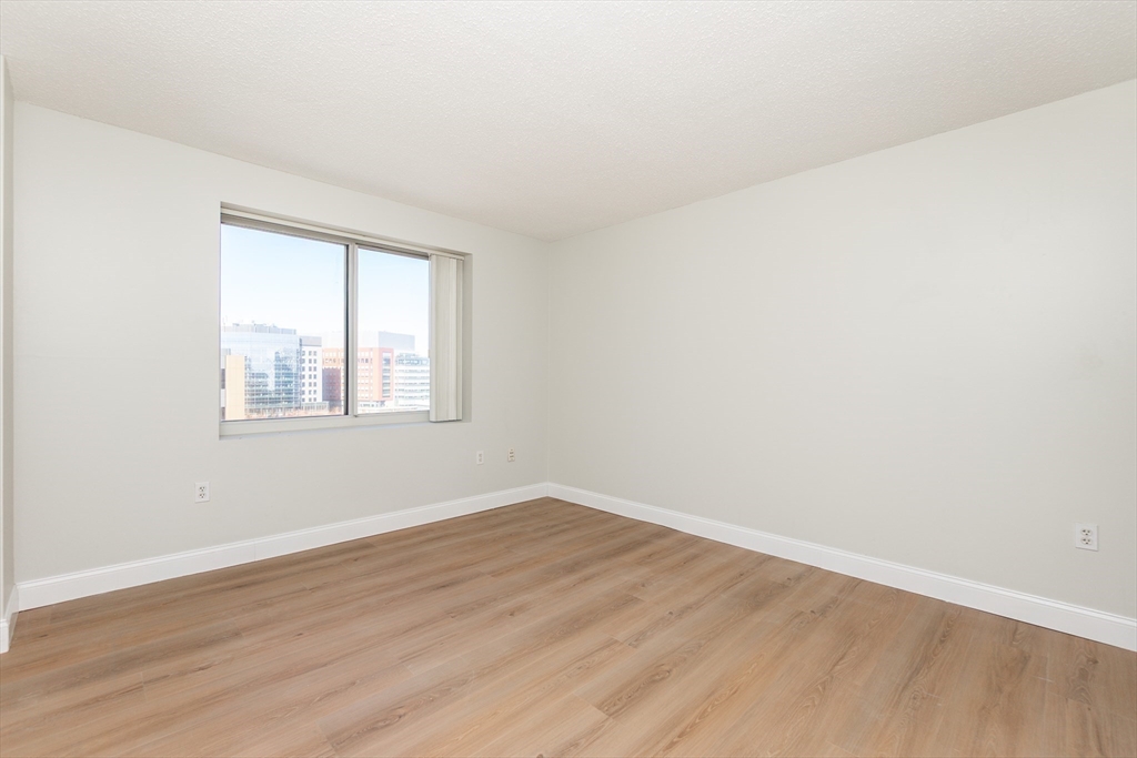 8-12 Museum Way, Unit 1224 Cambridge, MA 02141 - Photo 11 of 18 an empty room with wooden floor and windows