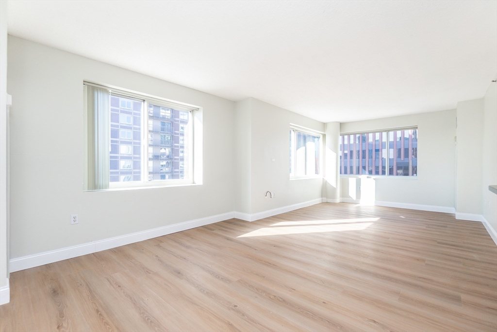 8-12 Museum Way, Unit 1224 Cambridge, MA 02141 - Photo 5 of 18 an empty room with wooden floor and windows