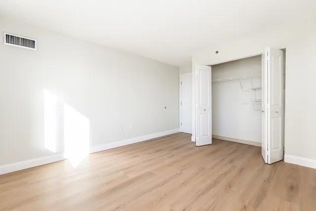 an empty room with wooden floor