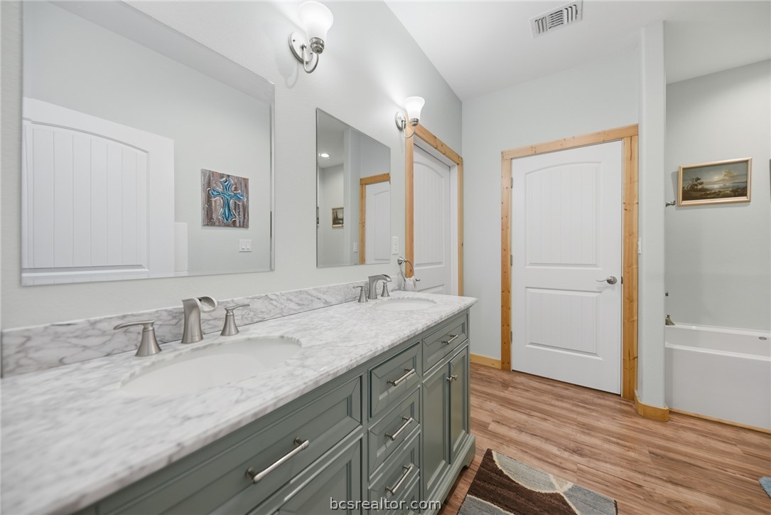 126 South Berlin Road Brenham, TX 77833 - Photo 16 of 30 a bathroom with a granite countertop sink mirror and double