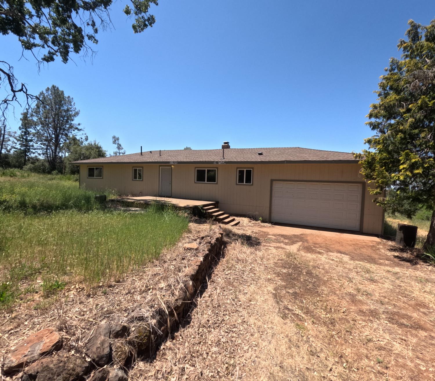21665 Manton School Road Manton, CA 96059 - Photo 2 of 30 a backyard of a house with a yard and lake view
