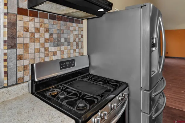 a close view of a stove and a refrigerator