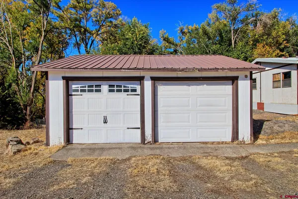 a view of a house with yard and sitting area