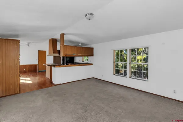 a kitchen with stainless steel appliances granite countertop a refrigerator a stove and a wooden floors