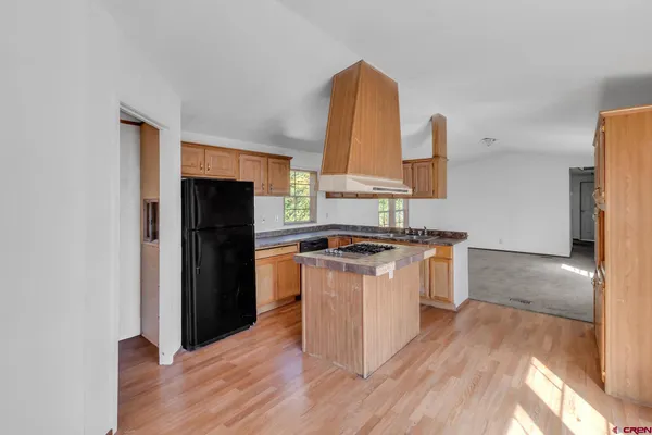 a kitchen with granite countertop a stove and a sink