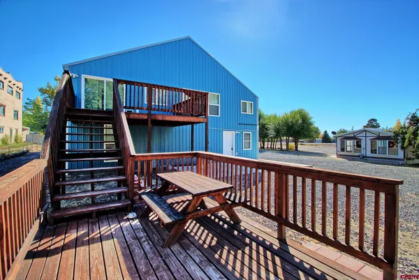 a view of balcony with wooden floor and outdoor seating
