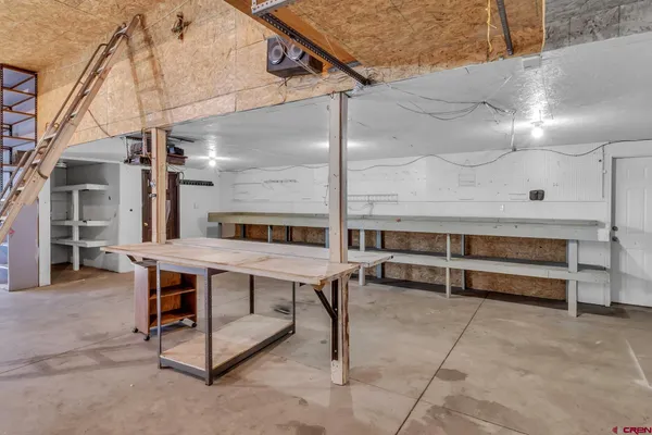 a roof deck with a table and chairs