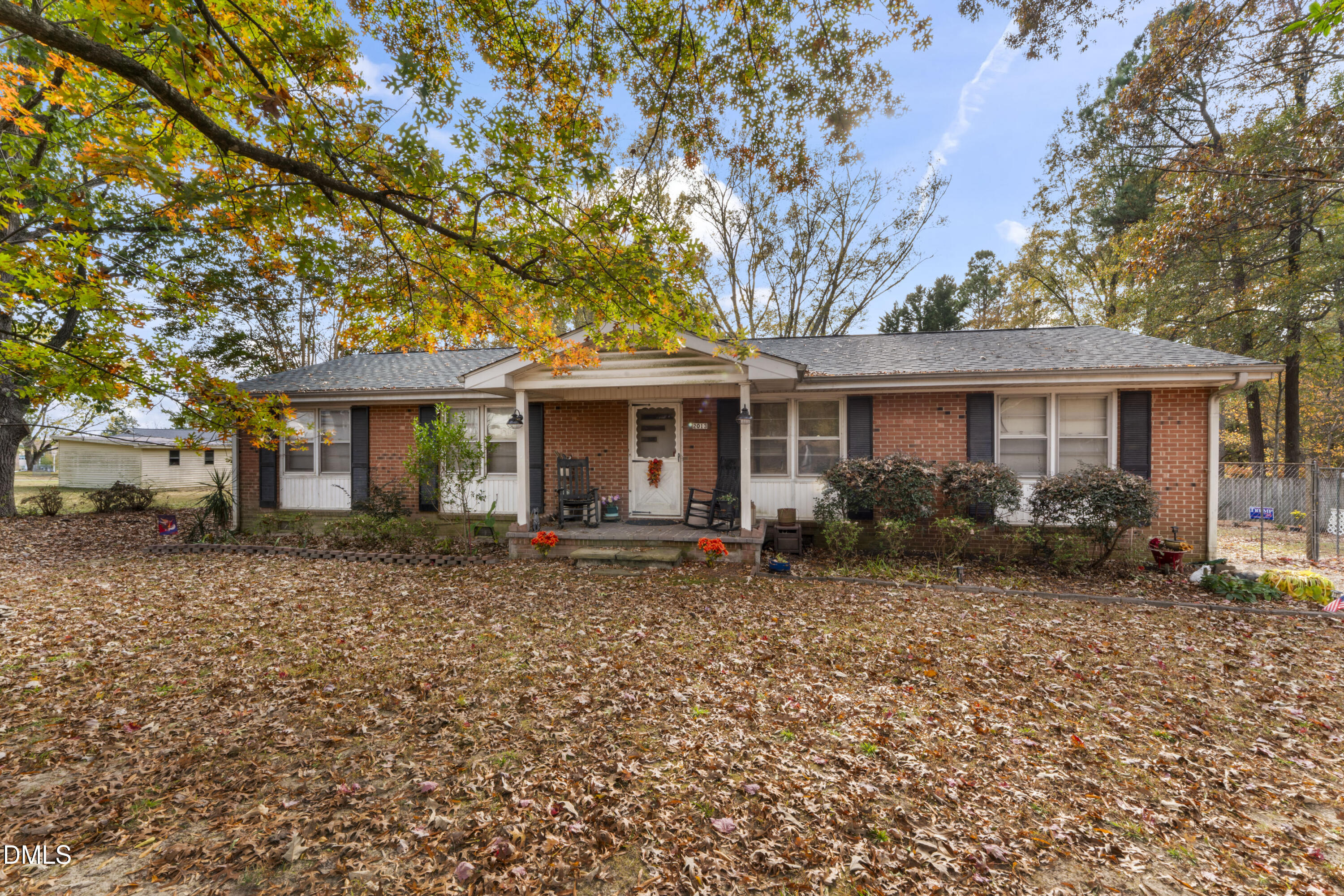 12329 Old Falls Of Neuse Road Wake Forest, NC 27587 - Photo 5 of 48 a front view of a house with garden
