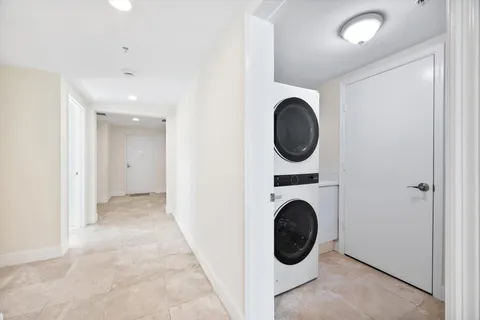 a view of a hallway with washer and dryer