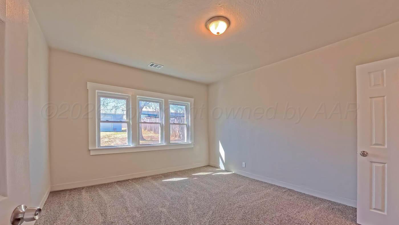1316 Withers Avenue Amarillo, TX 79108 - Photo 8 of 19 an empty room with windows