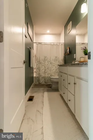 a bathroom with shower sink and mirror
