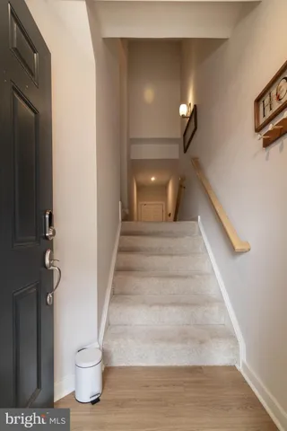 a view of entryway and hall with wooden floor