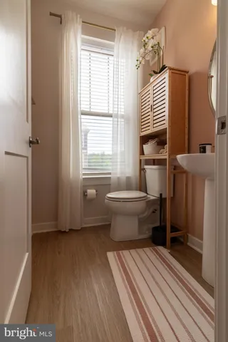 a room with wooden floor and windows