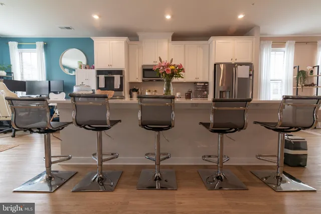 a room with lots of chairs and mirrors