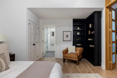 a bedroom with a bed and a couch next to a window