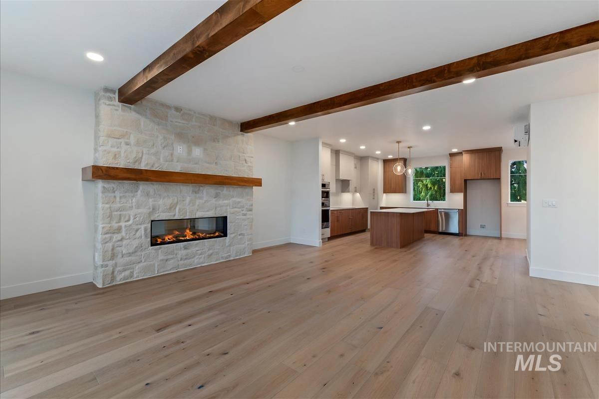 3213 West Moore Street Boise, ID 83702 - Photo 9 of 32 Spacious interior showcasing wood-finish flooring and exposed wood beams
