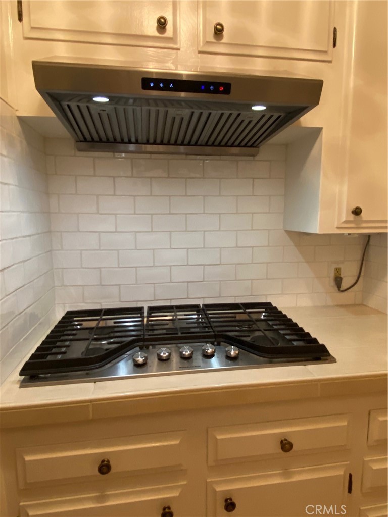 1595 Los Osos Valley Road, Unit 8A Los Osos, CA 93402 - Photo 33 of 73 a close view of a stove a microwave oven and cabinets