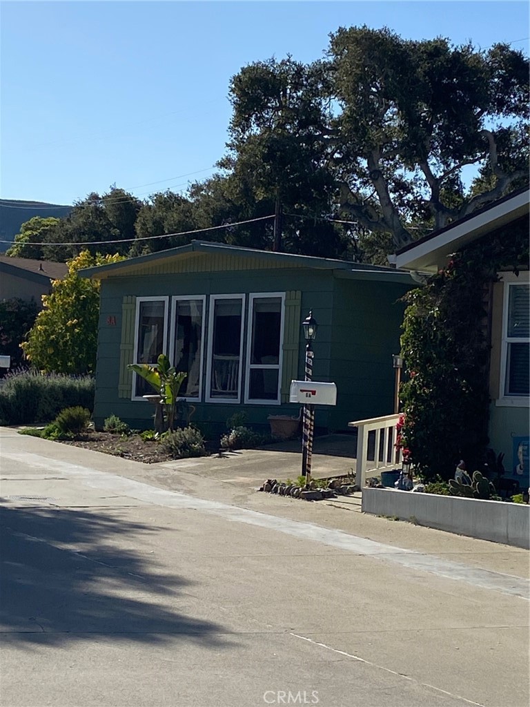 1595 Los Osos Valley Road, Unit 8A Los Osos, CA 93402 - Photo 42 of 73 front view of house with a bench and potted plants