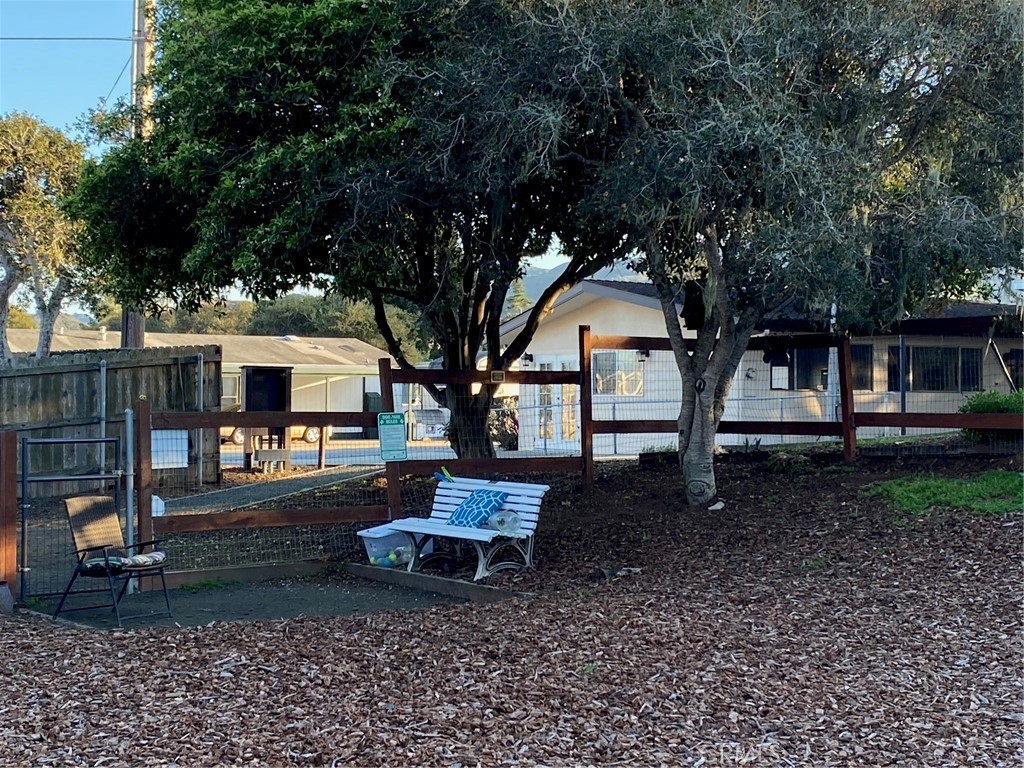 1595 Los Osos Valley Road, Unit 8A Los Osos, CA 93402 - Photo 52 of 73 a backyard of a house with barbeque oven fire pit table and chairs