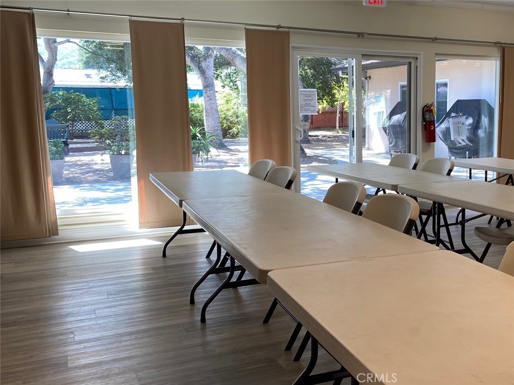 1595 Los Osos Valley Road, Unit 8A Los Osos, CA 93402 - Photo 61 of 73 a view of a dining room with furniture window and wooden floor
