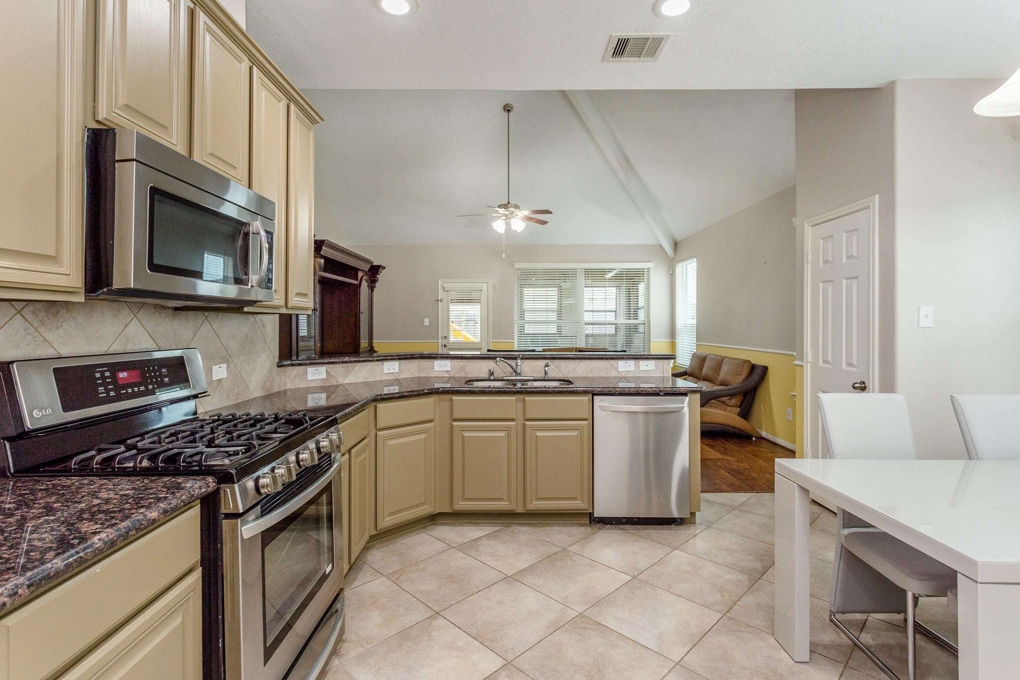 3430 Lilac Ranch Drive Katy, TX 77494 - Photo 9 of 29 a kitchen with a sink stove and microwave