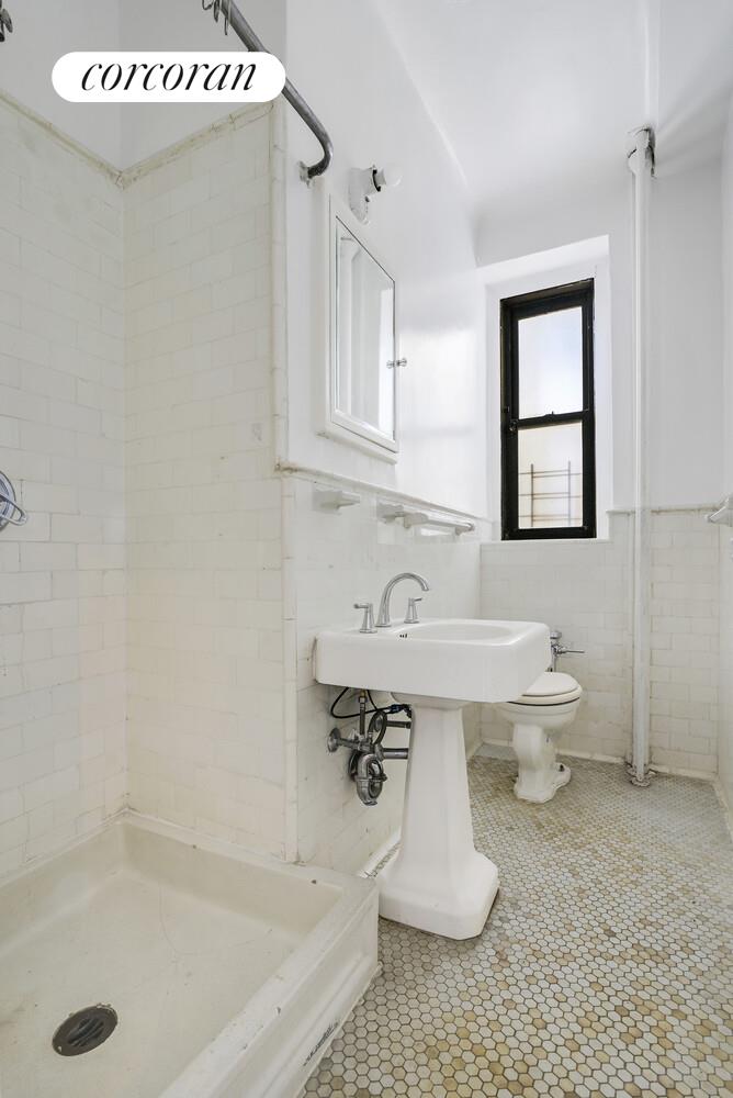 409 Edgecombe Avenue, Unit 2A Manhattan, NY 10032 - Photo 14 of 19 a bathroom with a sink a toilet and a bathtub