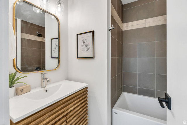 3813 North Foothill Drive Provo, UT 84604 - Photo 28 of 71 Contemporary bathroom featuring a wood-finish vanity with an integrated sink and chrome faucet