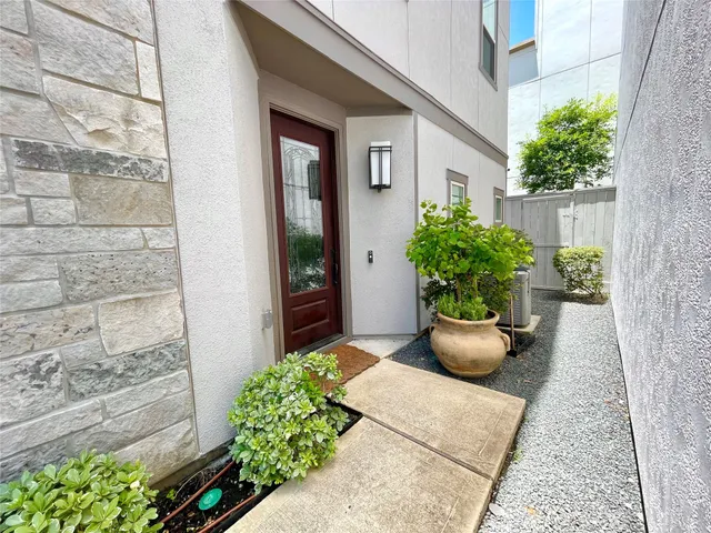 a living room with furniture a flat screen tv and a large window