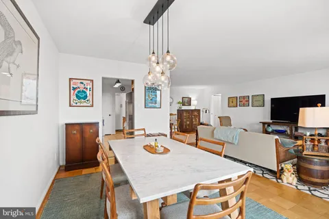 a view of a dining room with furniture and wooden floor
