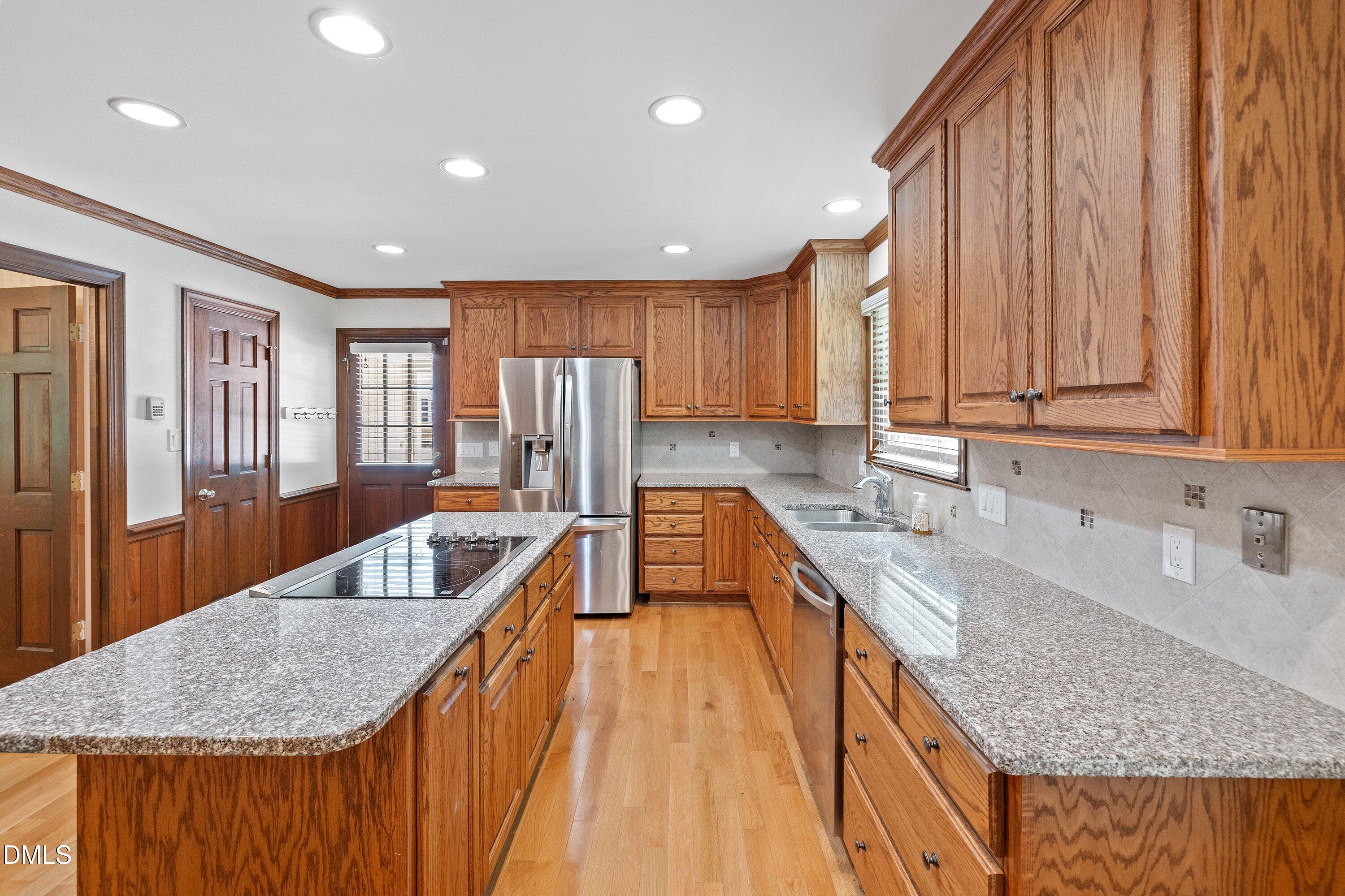 8133 Holly Forest Road Wake Forest, NC 27587 - Photo 15 of 50 a kitchen with granite countertop a sink a counter top space and cabinets
