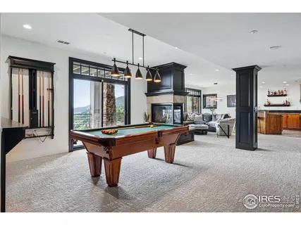 a open kitchen with stainless steel appliances kitchen island granite countertop a black and white cabinets