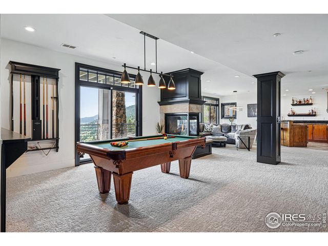 a open kitchen with stainless steel appliances kitchen island granite countertop a black and white cabinets