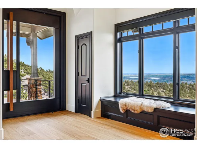 a bedroom with furniture and large window