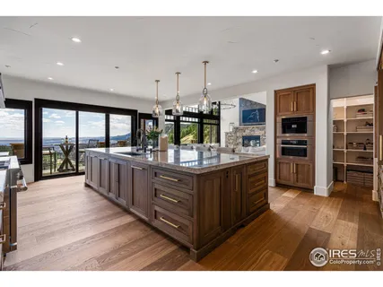 a kitchen with stainless steel appliances kitchen island granite countertop a large center island and a wooden cabinets