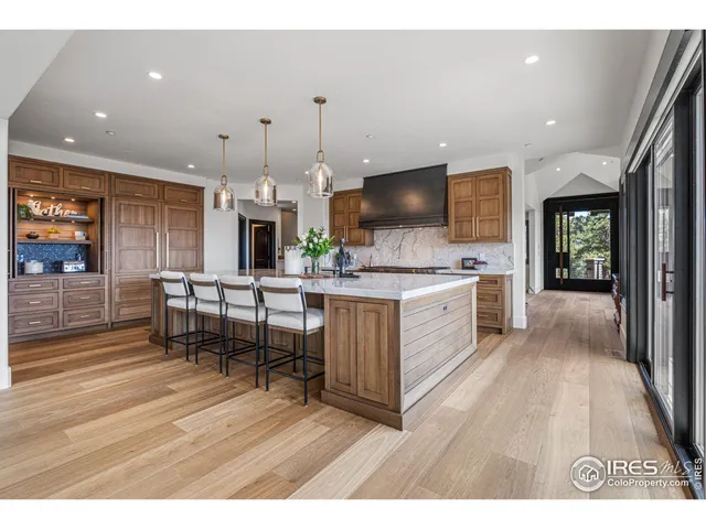 a open kitchen with stainless steel appliances kitchen island granite countertop a stove a sink and a refrigerator