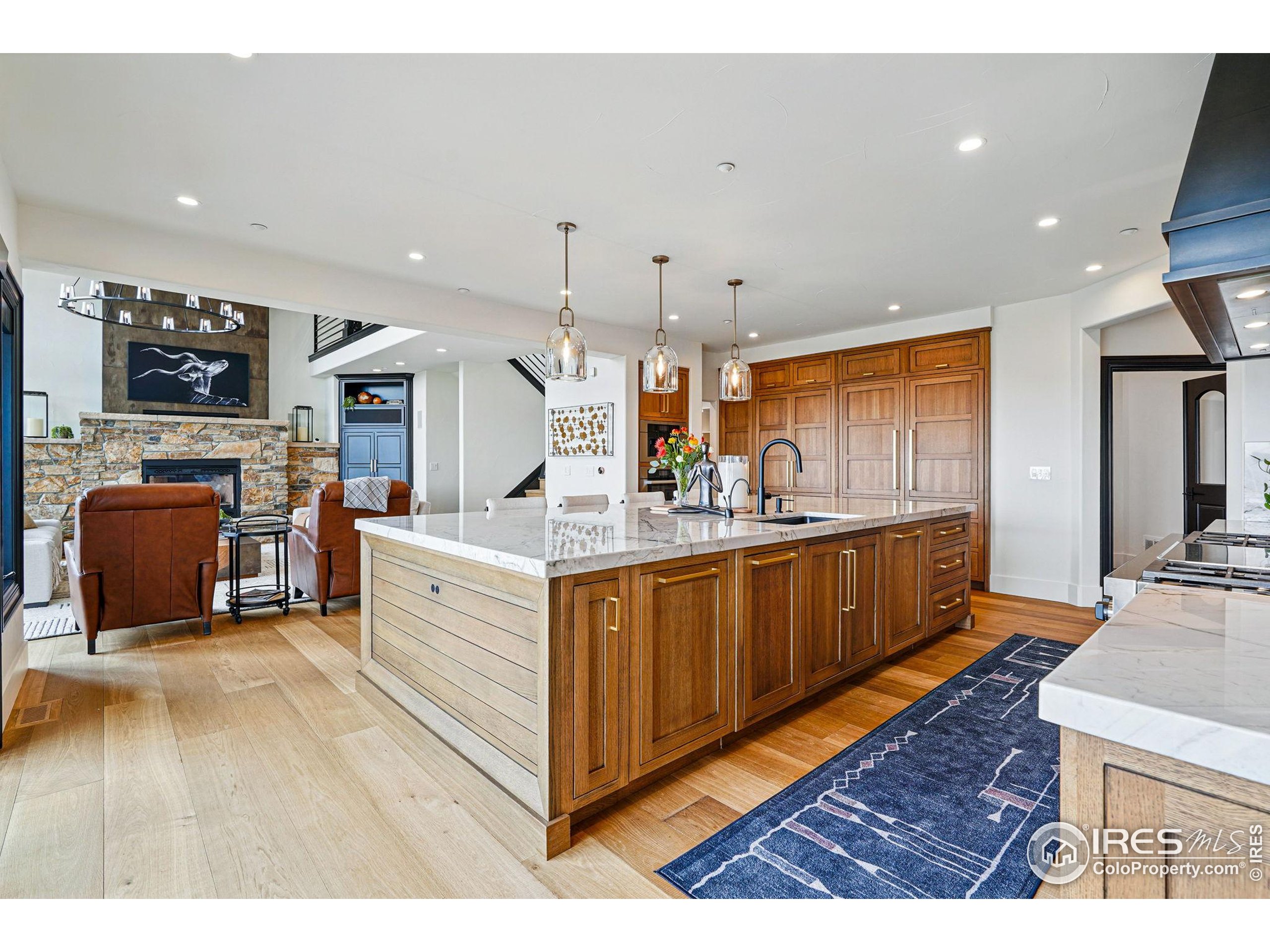 166 Valley View Way Boulder, CO 80304 - Photo 10 of 40 a large white kitchen with stainless steel appliances kitchen island granite countertop a large counter top and a stove