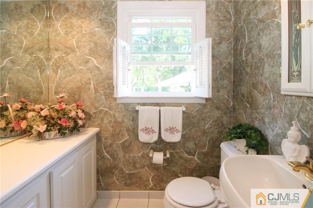 20 Corey Drive Ewing, NJ 08618 - Photo 19 of 25 a bathroom with a toilet sink and mirror