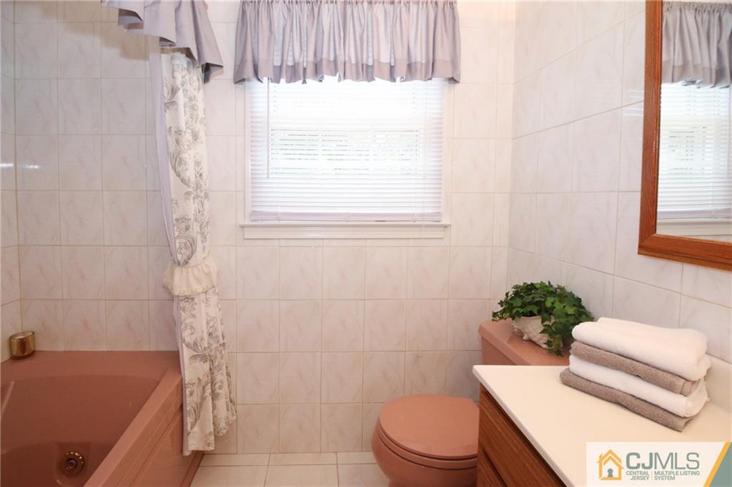 20 Corey Drive Ewing, NJ 08618 - Photo 20 of 25 a bathroom with a sink a toilet and shower