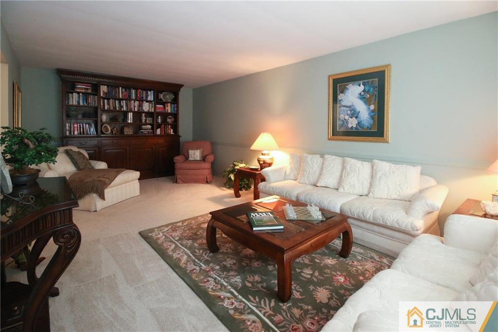 20 Corey Drive Ewing, NJ 08618 - Photo 4 of 25 a living room with furniture a rug and a bookshelf