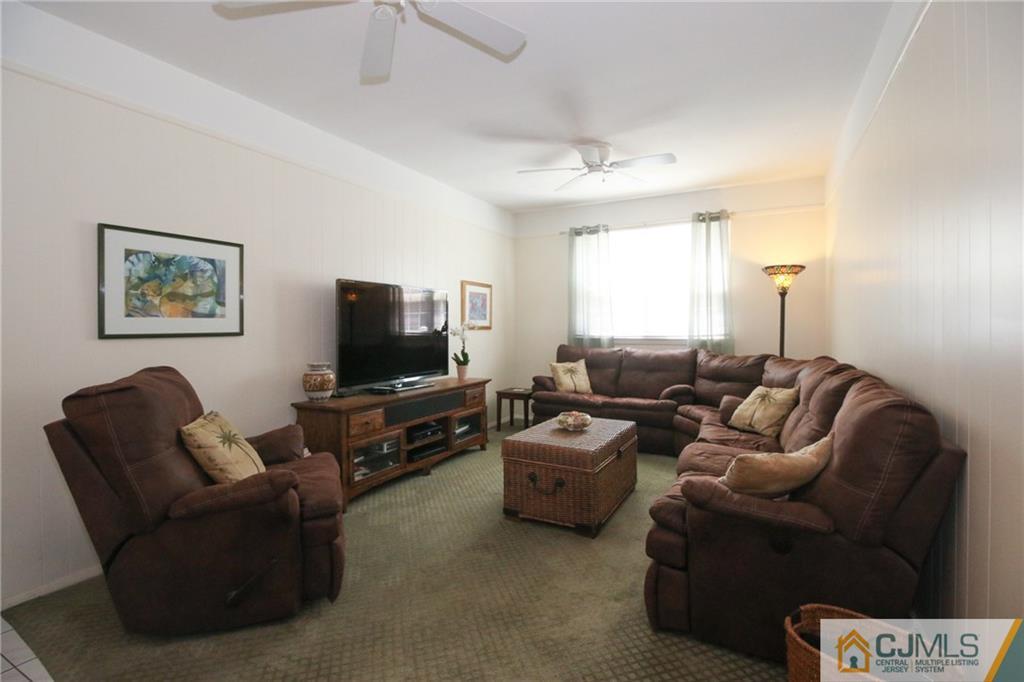 20 Corey Drive Ewing, NJ 08618 - Photo 6 of 25 a living room with furniture and a flat screen tv