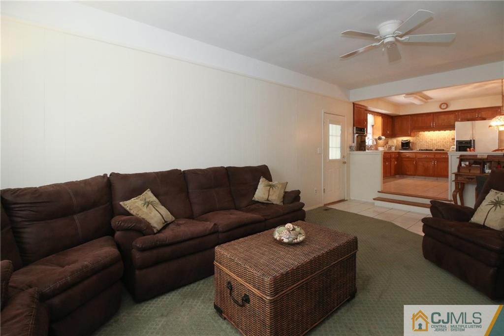 20 Corey Drive Ewing, NJ 08618 - Photo 7 of 25 a living room with furniture and a chandelier