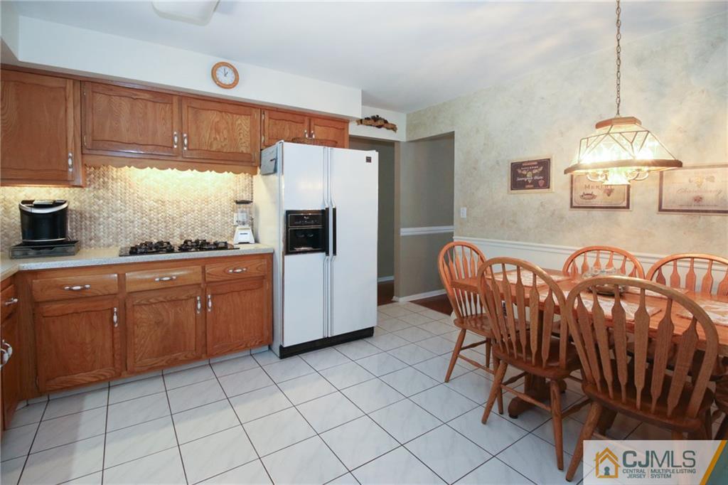 20 Corey Drive Ewing, NJ 08618 - Photo 8 of 25 a kitchen with granite countertop a stove a sink and a refrigerator